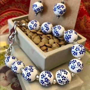 Bracelet with white glass beads with blue flowers.